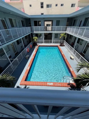 a living room with a couch and bookshelf