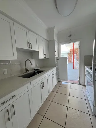 a kitchen with stainless steel appliances granite countertop a sink a stove a refrigerator and cabinets