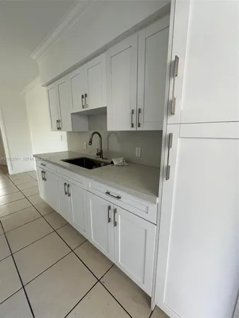 a kitchen with stainless steel appliances granite countertop a sink and a stove