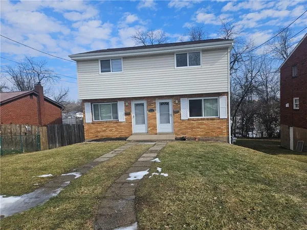 a front view of a house with a yard