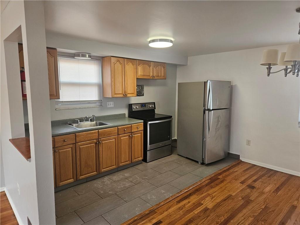 812 Westbury Road, Unit A North Versailles, PA 15137 - Photo 12 of 40 a kitchen with stainless steel appliances granite countertop a refrigerator stove and sink