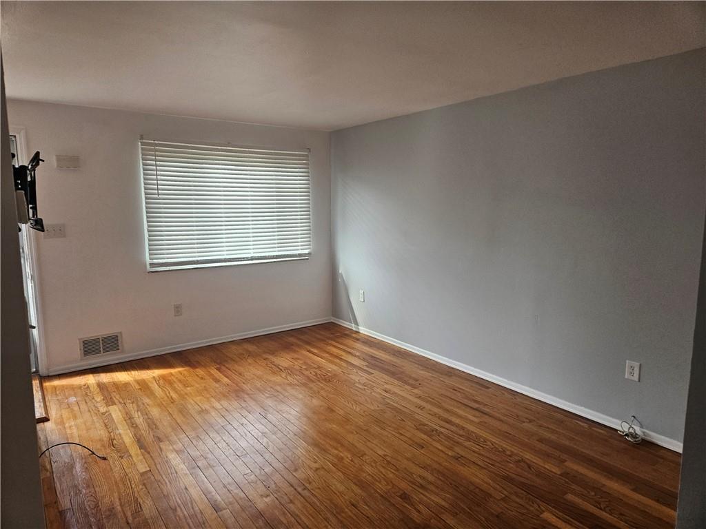812 Westbury Road, Unit A North Versailles, PA 15137 - Photo 15 of 40 an empty room with wooden floor and windows