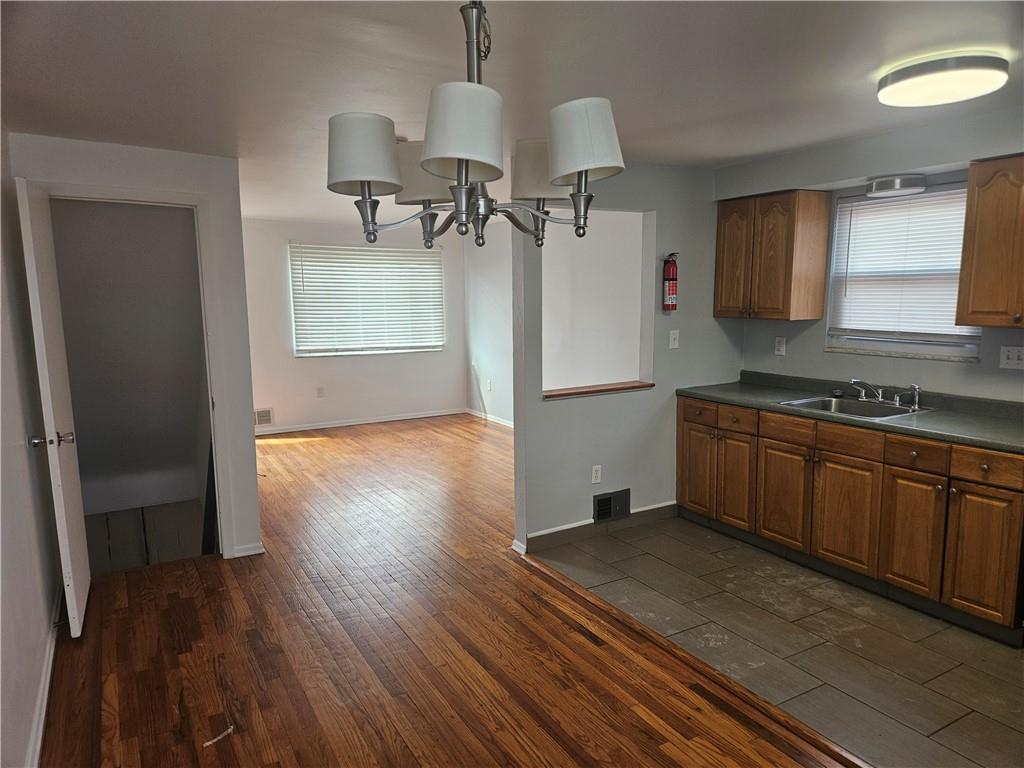 812 Westbury Road, Unit A North Versailles, PA 15137 - Photo 16 of 40 a kitchen with wooden floors and a sink