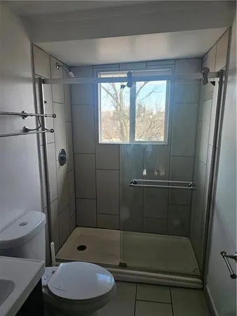 a toilet sitting next to a bathroom sink