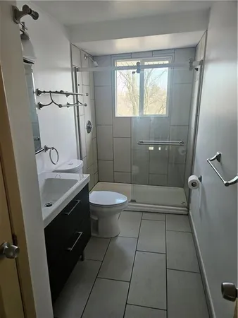 a bathroom with a shower and a toilet