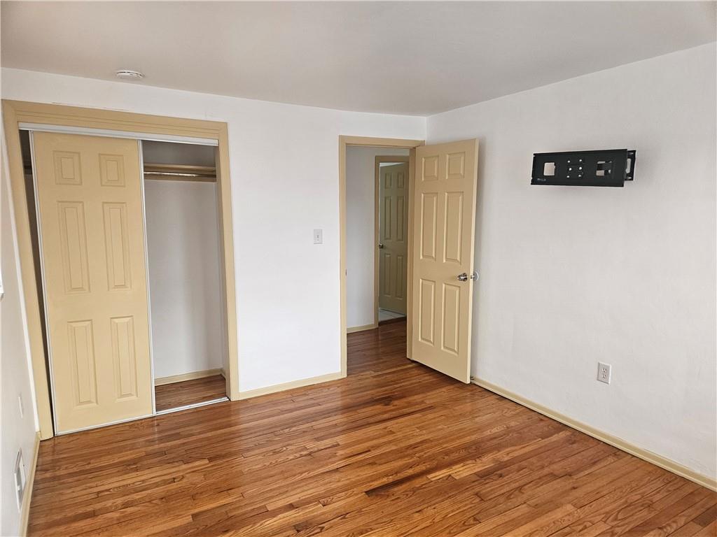 812 Westbury Road, Unit A North Versailles, PA 15137 - Photo 28 of 40 a view of an empty room with wooden floor