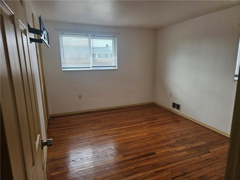 812 Westbury Road, Unit A North Versailles, PA 15137 - Photo 30 of 40 an empty room with wooden floor and windows