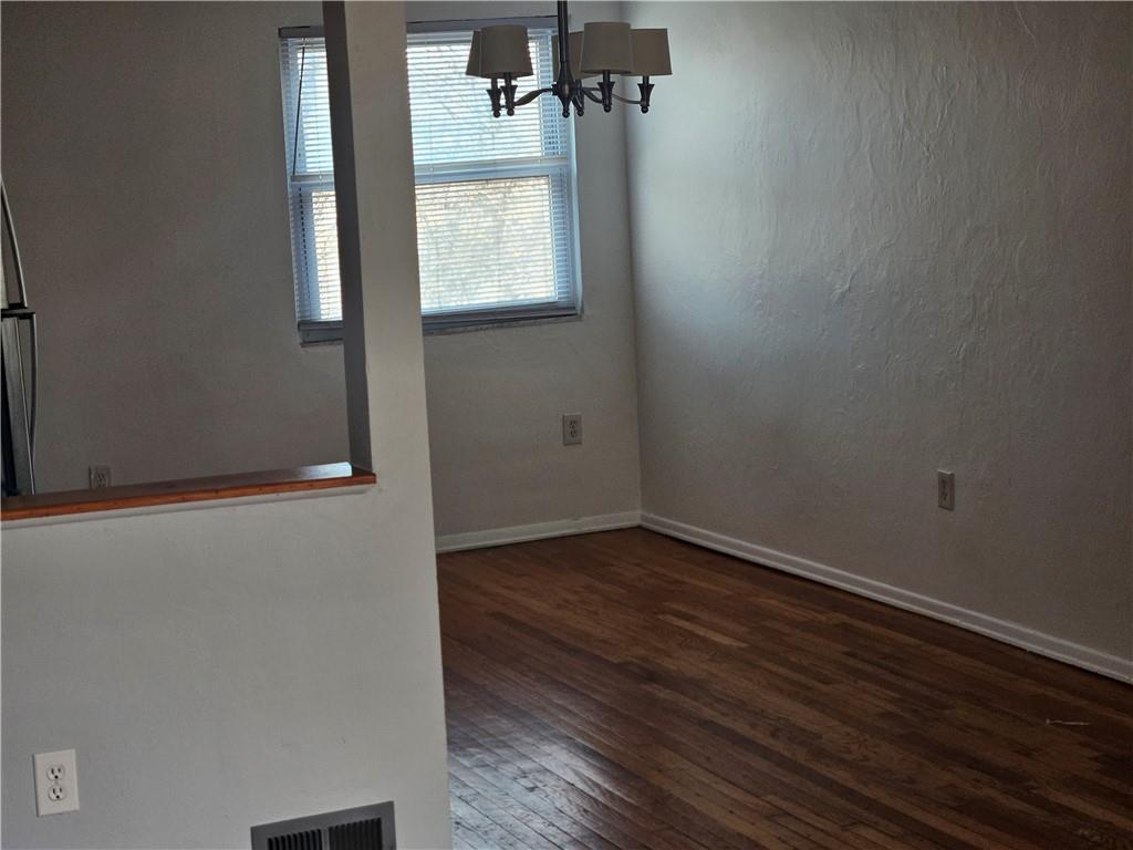 812 Westbury Road, Unit A North Versailles, PA 15137 - Photo 6 of 40 an empty room with wooden floor and windows