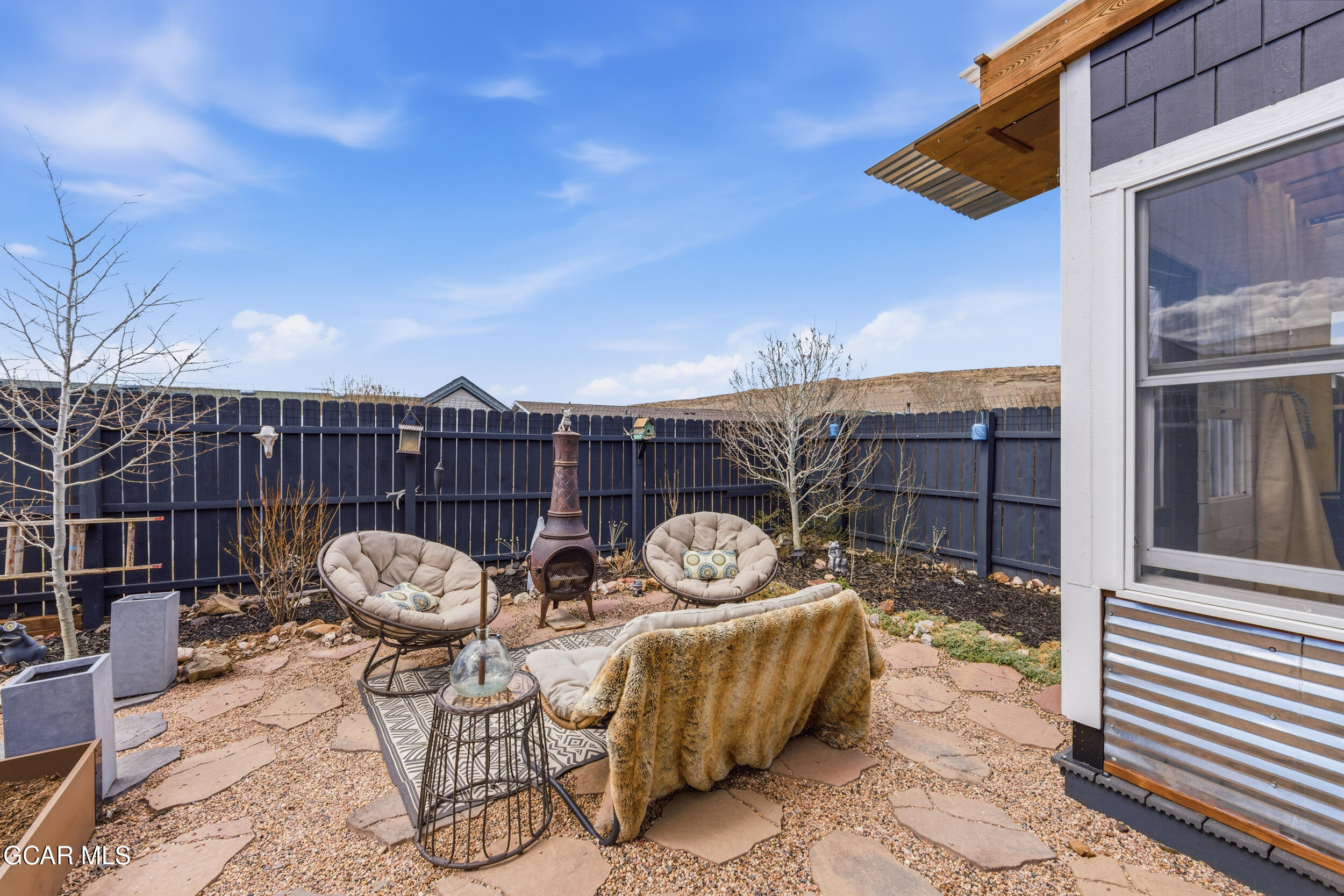 503 12th Street, Unit B Kremmling, CO 80459 - Photo 30 of 44 a view of a chair and tables in the patio