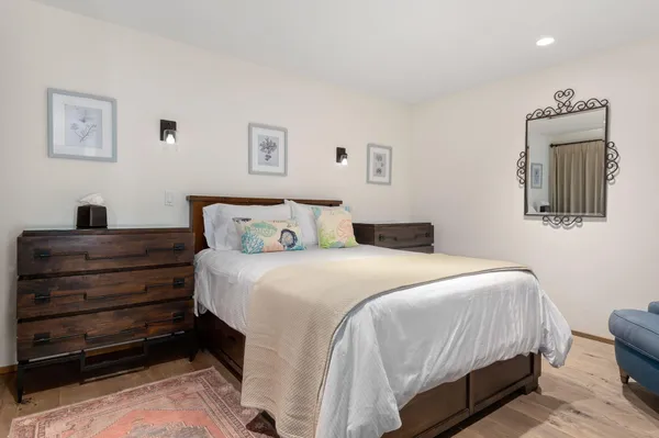 a bedroom with a bed and a mirror