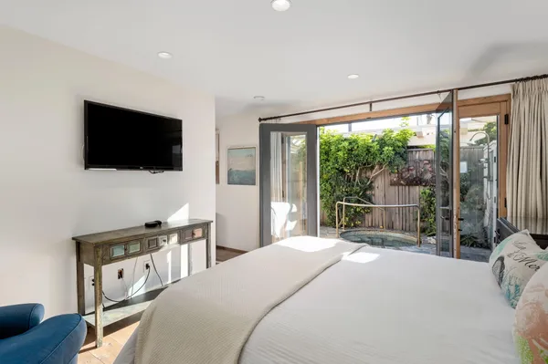 a bedroom with a bed and a flat screen tv