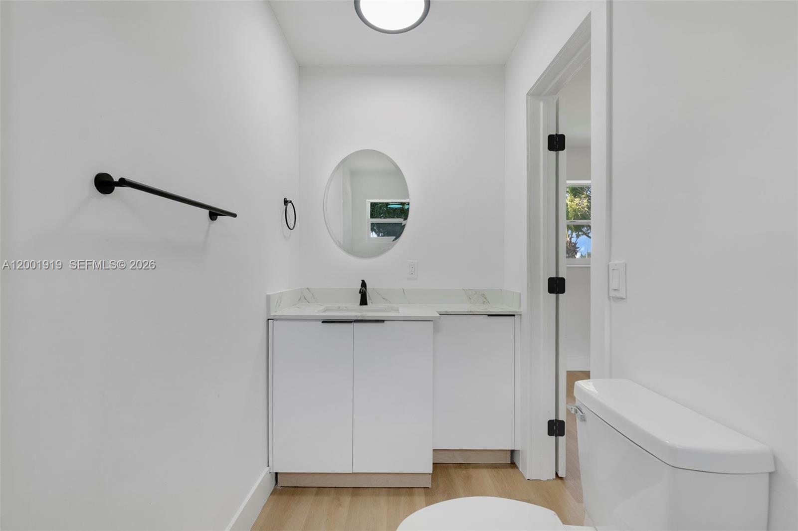 7970 Northwest 176th Street Hialeah, FL 33015 - Photo 11 of 32 a bathroom with a toilet a sink and mirror