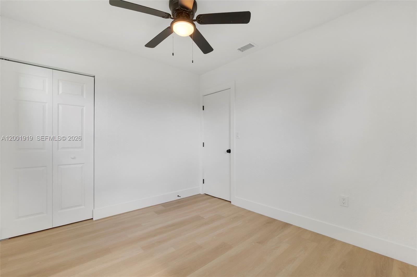 7970 Northwest 176th Street Hialeah, FL 33015 - Photo 15 of 32 wooden floor in an empty room