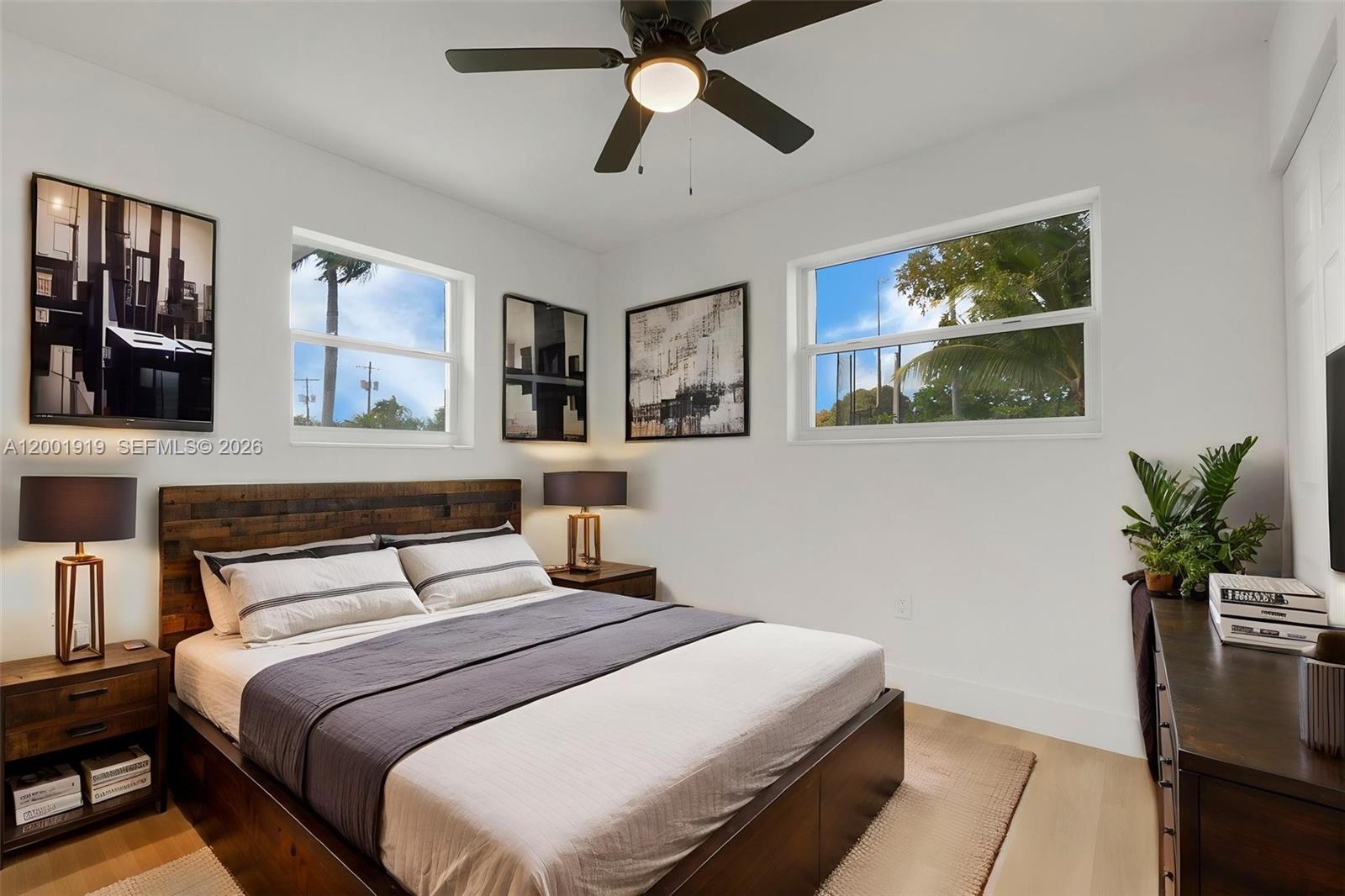 7970 Northwest 176th Street Hialeah, FL 33015 - Photo 17 of 32 a bedroom with a bed and a potted plant on the dresser