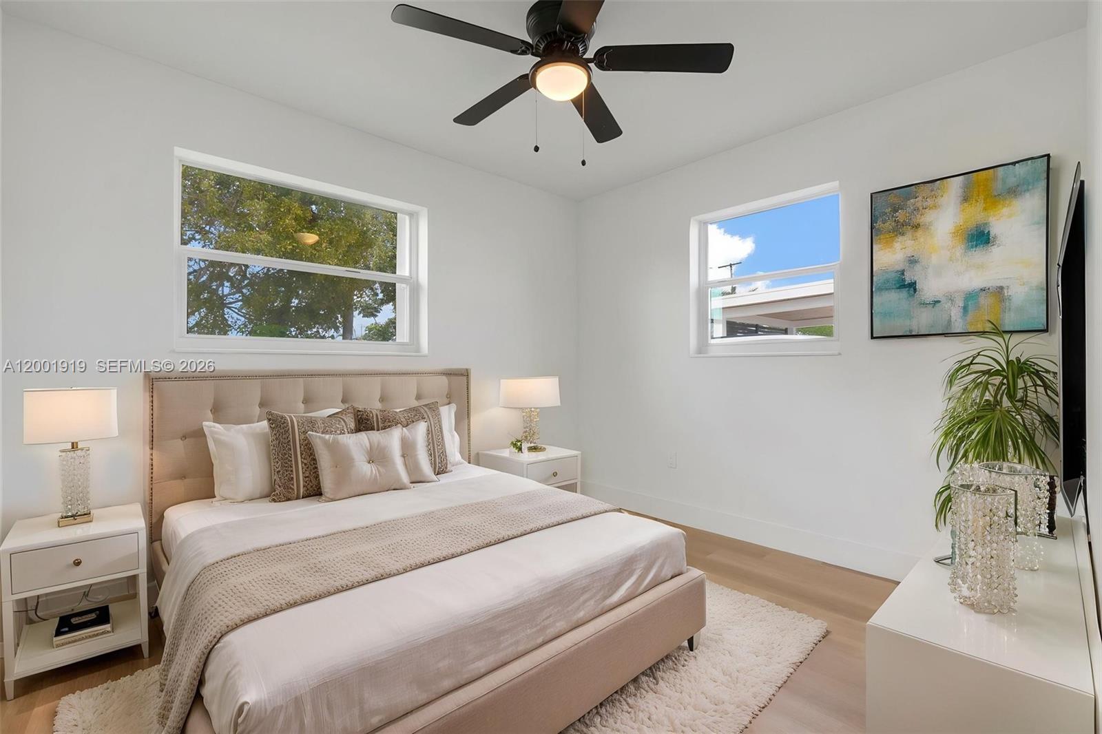 7970 Northwest 176th Street Hialeah, FL 33015 - Photo 20 of 32 a bedroom with a bed and a painting on the wall