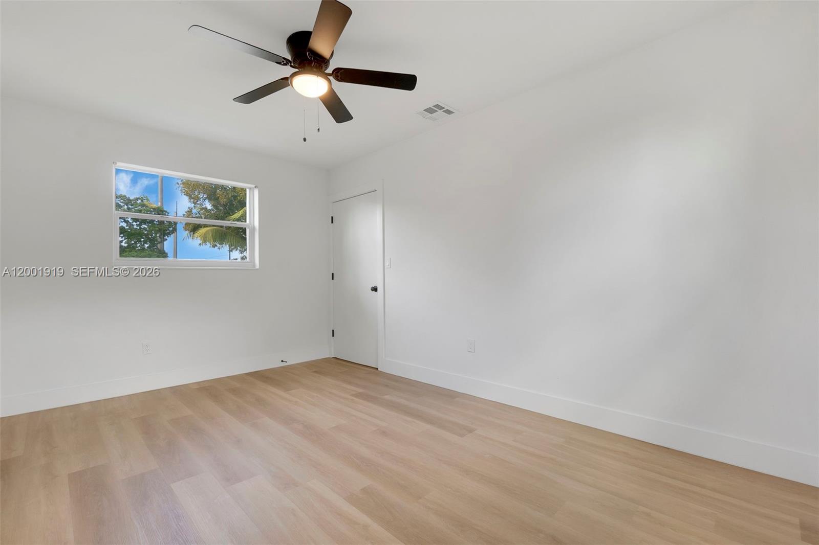 7970 Northwest 176th Street Hialeah, FL 33015 - Photo 21 of 32 a view of room with hardwood floor and a ceiling fan
