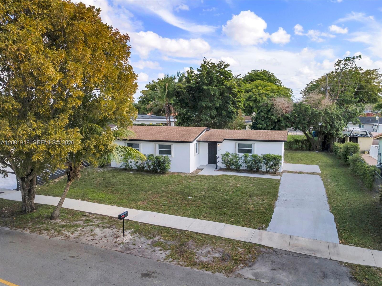 7970 Northwest 176th Street Hialeah, FL 33015 - Photo 3 of 32 front view of a house with a yard