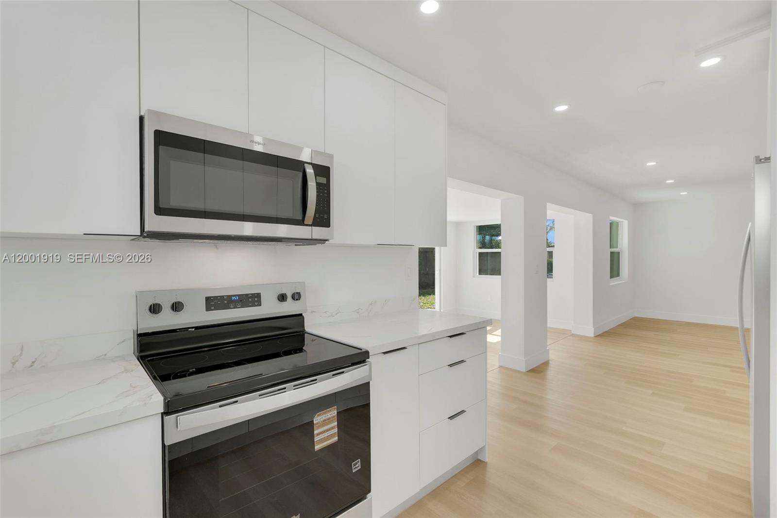 7970 Northwest 176th Street Hialeah, FL 33015 - Photo 6 of 32 a kitchen with stainless steel appliances a stove microwave and refrigerator