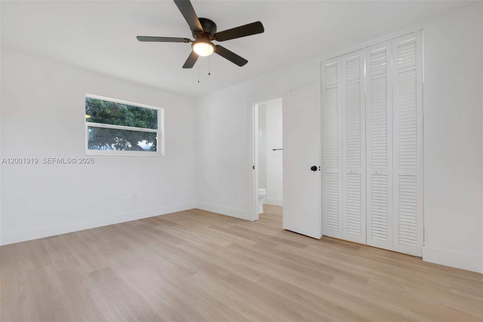 7970 Northwest 176th Street Hialeah, FL 33015 - Photo 8 of 32 an empty room with a window and a fan