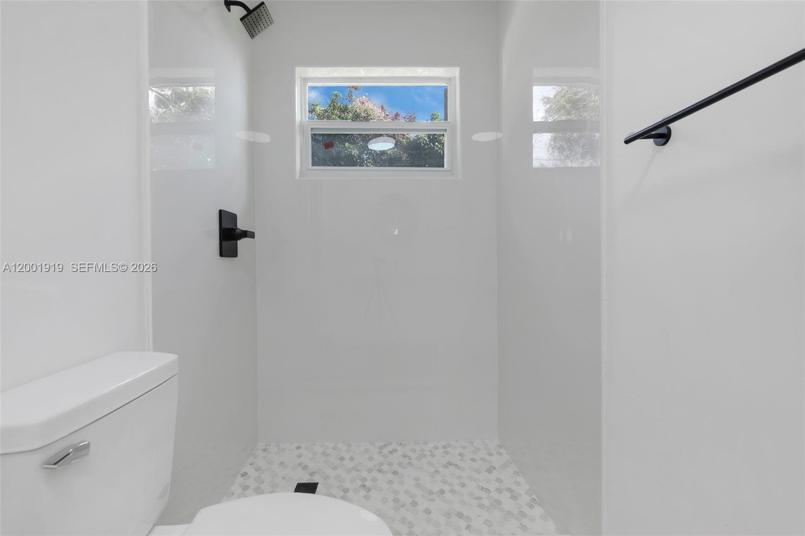 7970 Northwest 176th Street Hialeah, FL 33015 - Photo 10 of 32 a bathroom with a toilet and a shower