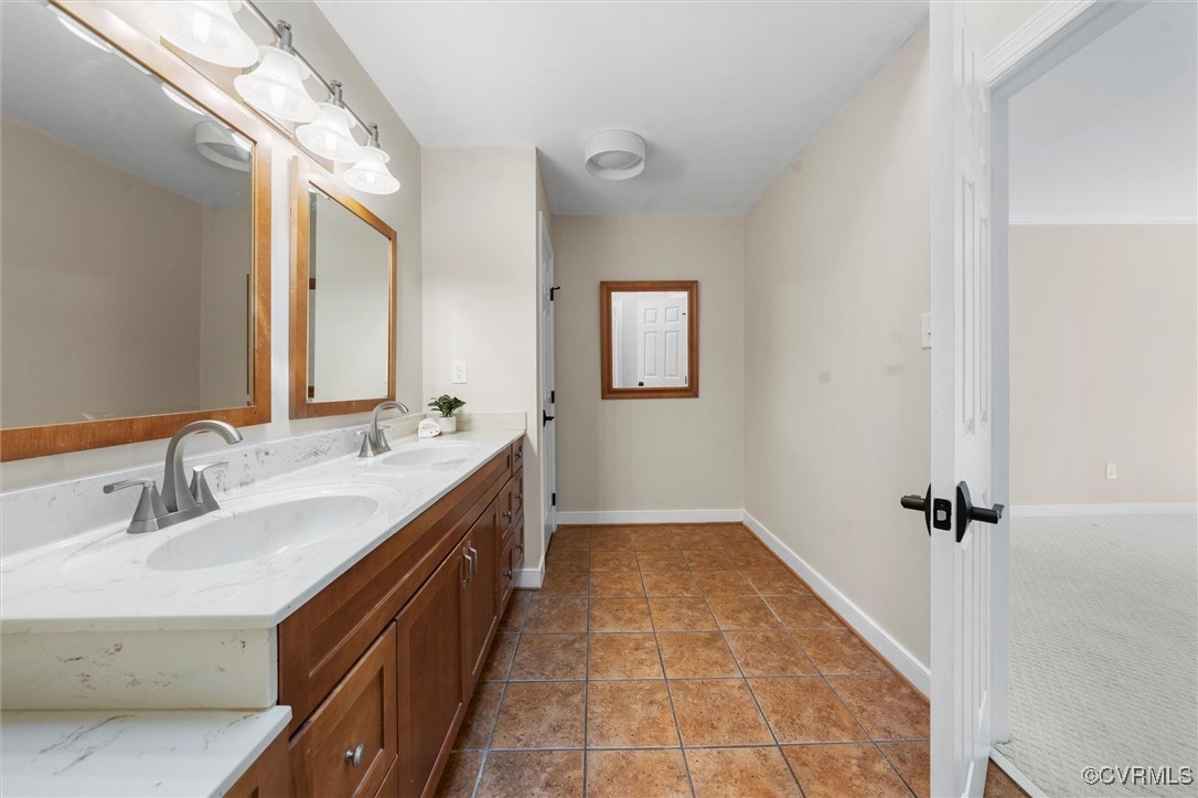 2430 Olde Stone Road Midlothian, VA 23113 - Photo 29 of 46 a bathroom with a sink a mirror and a bathtub
