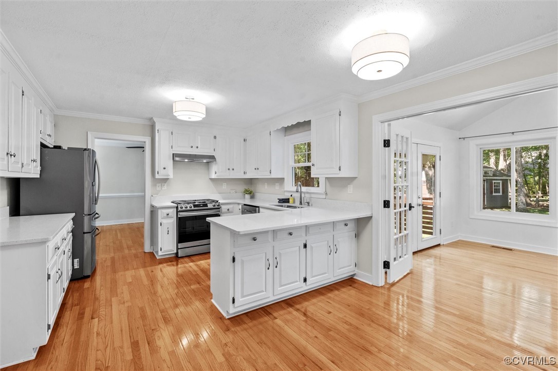 2430 Olde Stone Road Midlothian, VA 23113 - Photo 6 of 46 a kitchen with granite countertop a stove a sink dishwasher and a refrigerator with wooden floor