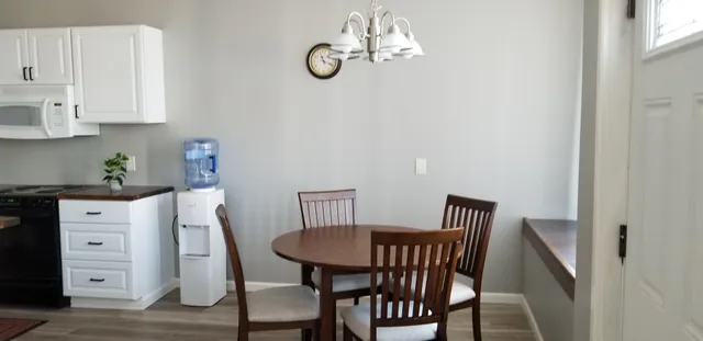 a view of a dining room with furniture and wooden floor