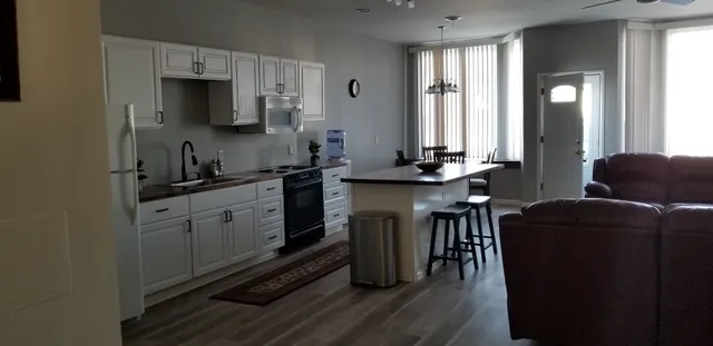 a kitchen with stainless steel appliances granite countertop a sink stove and microwave