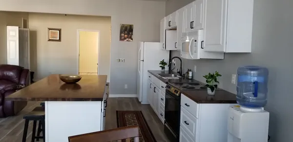 a kitchen with stainless steel appliances a sink stove and cabinets