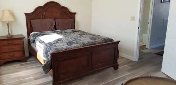 a bed sitting in a bedroom next to a wooden floor