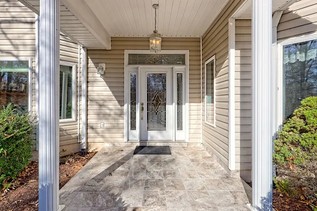 a dining room with furniture window and wooden floor