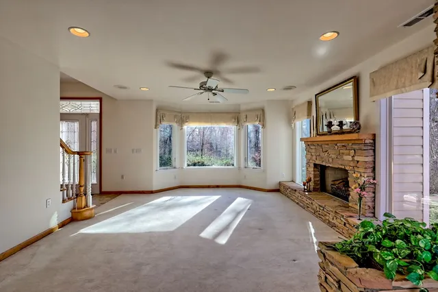 a kitchen with stainless steel appliances granite countertop a refrigerator a stove top oven a sink and dishwasher