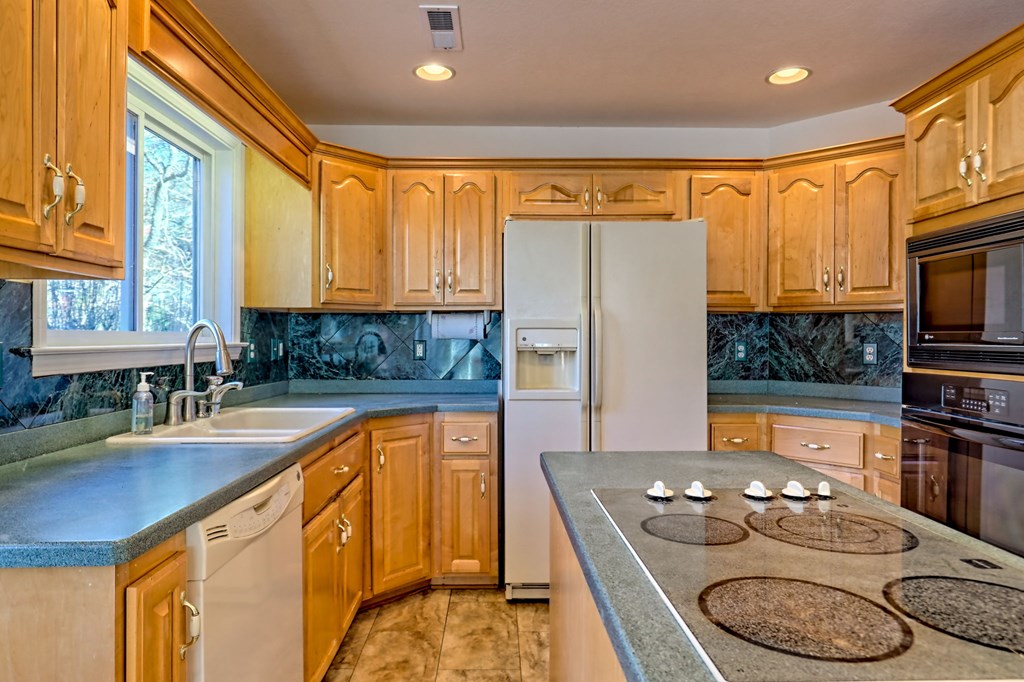 838 Peachtree Hills Road Murphy, NC 28906 - Photo 29 of 92 a kitchen with stainless steel appliances granite countertop a sink stove and cabinets