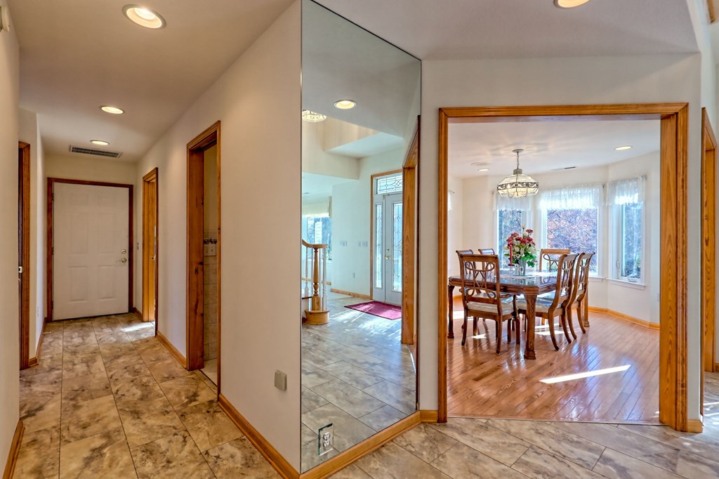 838 Peachtree Hills Road Murphy, NC 28906 - Photo 39 of 92 a view of a dining room and livingroom with furniture wooden floor a rug a fireplace and a chandelier