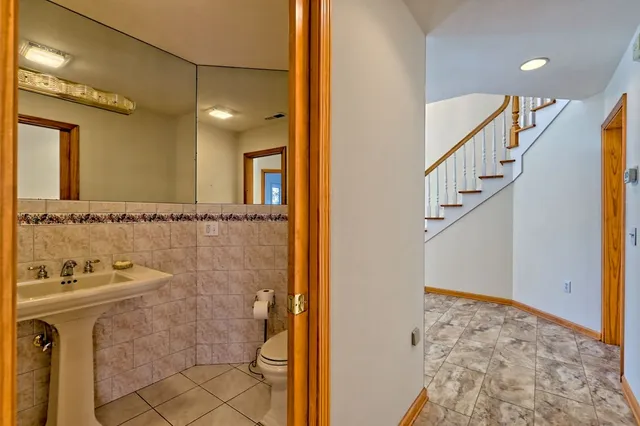 a bathroom with a bathtub sink and mirror