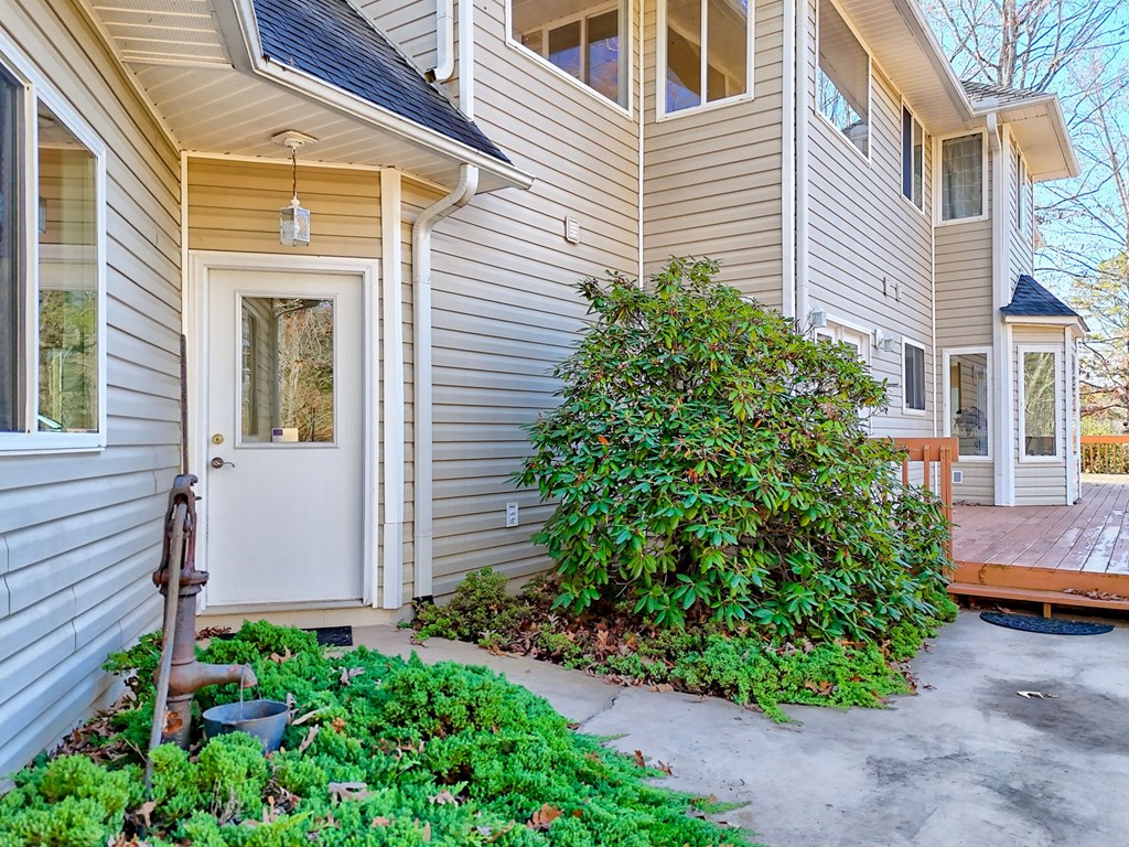 838 Peachtree Hills Road Murphy, NC 28906 - Photo 6 of 92 a view of a house with potted plants and a bench
