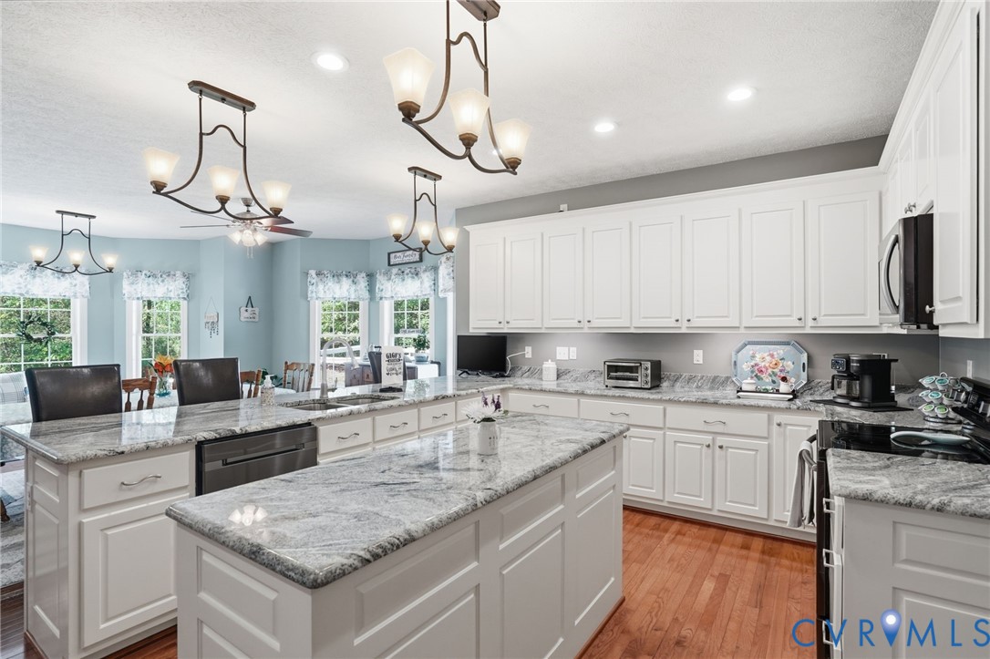 3600 Market Road Mechanicsville, VA 23111 - Photo 14 of 67 a kitchen with kitchen island granite countertop a sink a counter space appliances and cabinets