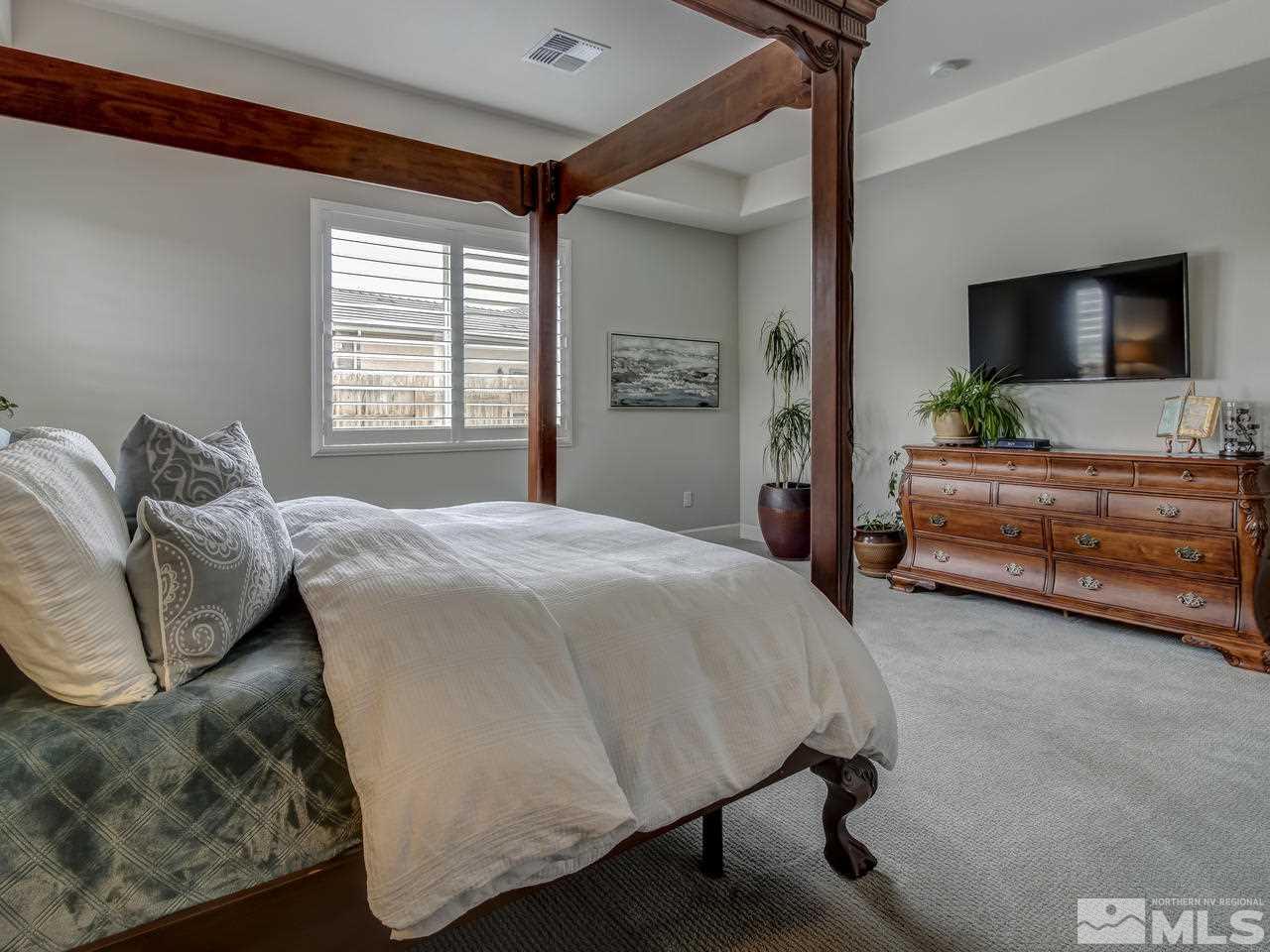2169 Gazala Lane Reno, NV 89521 - Photo 14 of 25 a bedroom with a bed and flat screen tv