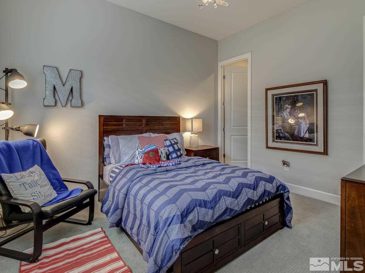 2169 Gazala Lane Reno, NV 89521 - Photo 16 of 25 a bedroom with a bed a dresser and painting