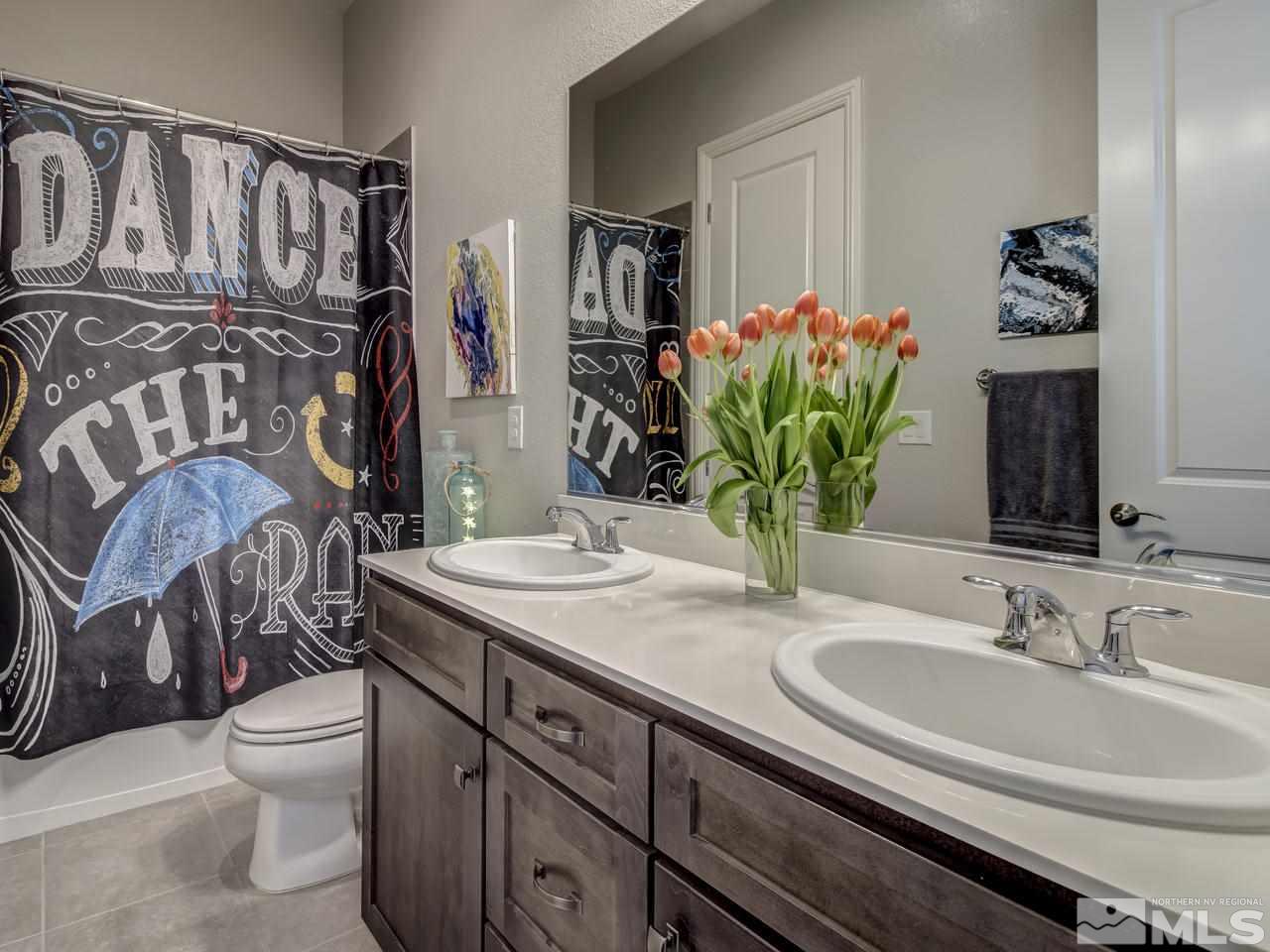 2169 Gazala Lane Reno, NV 89521 - Photo 18 of 25 a bathroom with a granite countertop sink a toilet and mirror