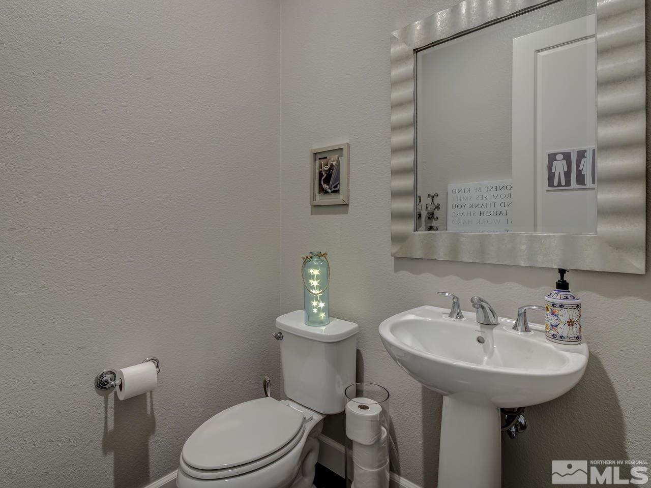 2169 Gazala Lane Reno, NV 89521 - Photo 19 of 25 a bathroom with a sink a toilet and mirror
