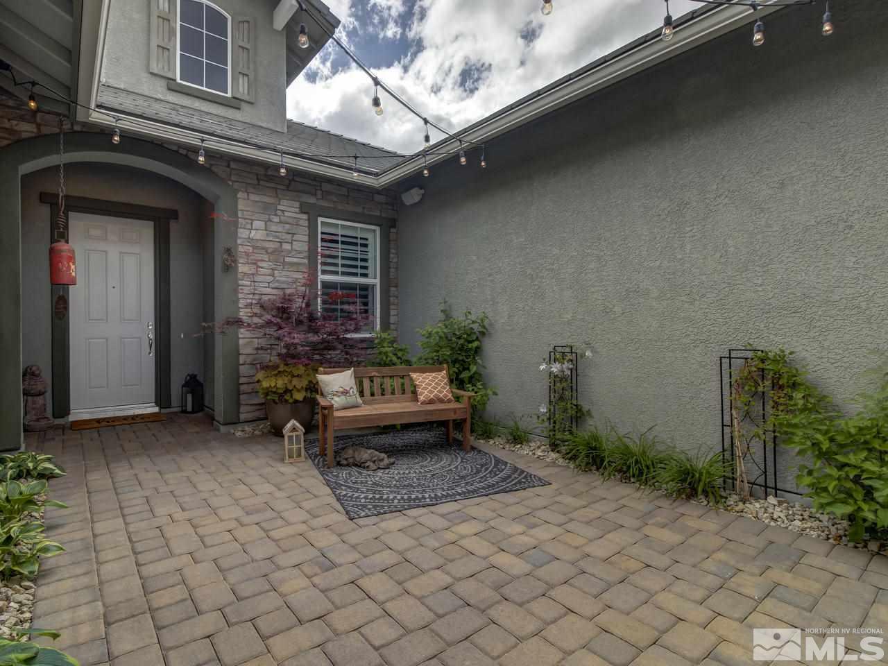 2169 Gazala Lane Reno, NV 89521 - Photo 2 of 25 a view of a house with a large window and potted plants