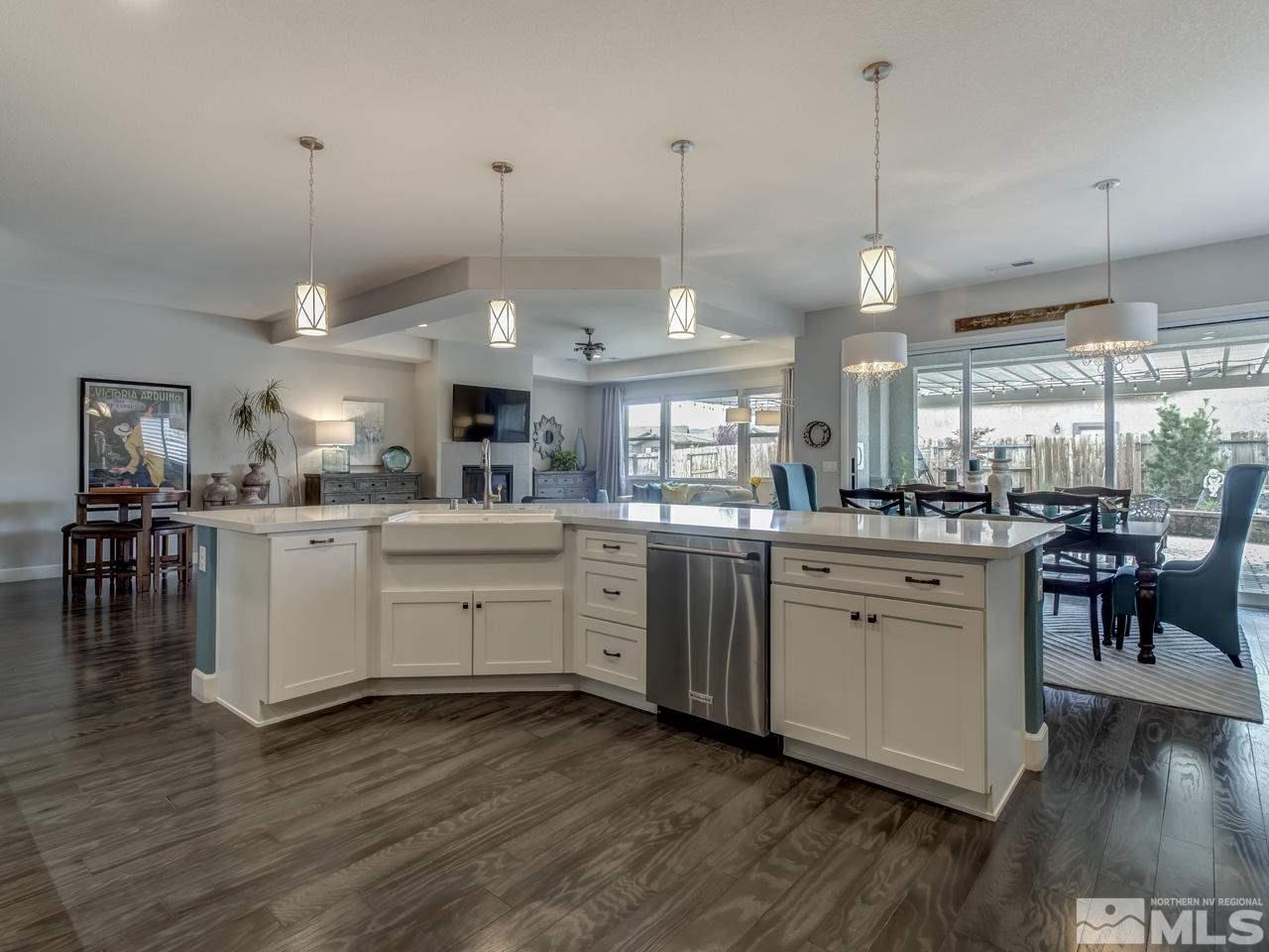 2169 Gazala Lane Reno, NV 89521 - Photo 4 of 25 a large kitchen with cabinets a sink a window and stainless steel appliances