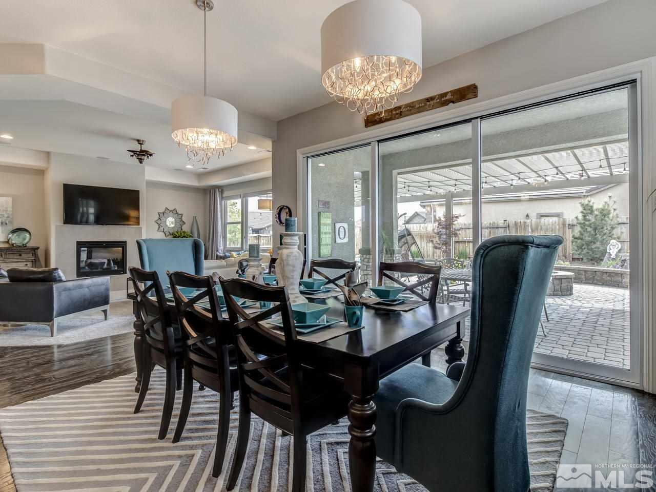 2169 Gazala Lane Reno, NV 89521 - Photo 6 of 25 a view of a dining room with furniture wooden floor and chandelier