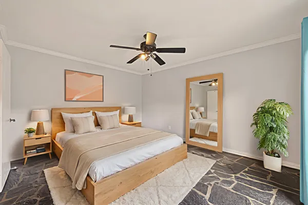 a bedroom with a bed and a potted plant