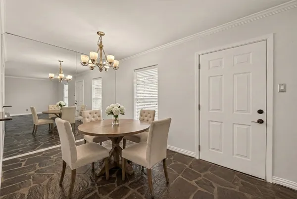 a view of a dining room with furniture and chandelier