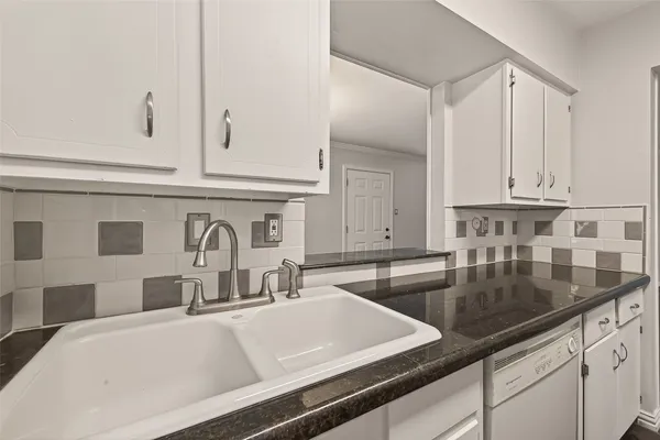 a kitchen with cabinets and window