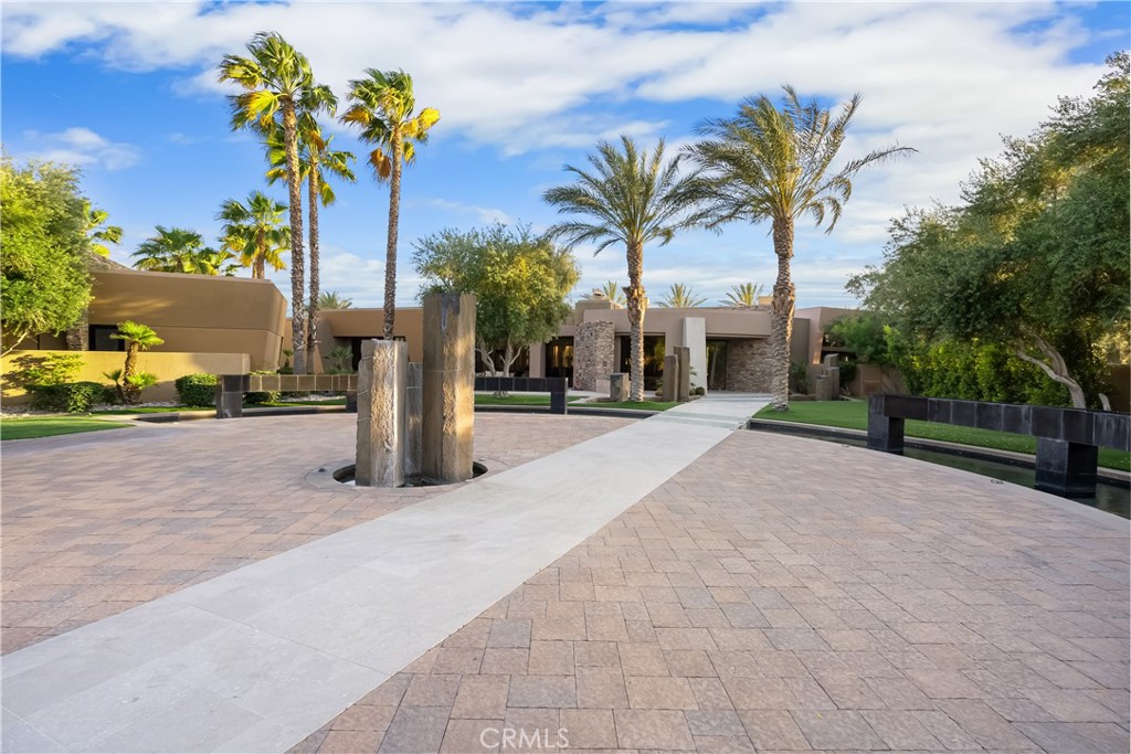 68 Royal St Georges Way Rancho Mirage, CA 92270 - Photo 21 of 75 a palm tree sitting in front of a building with cars parked