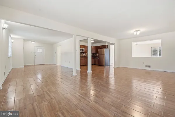 a view of a refrigerator in kitchen and wooden floor