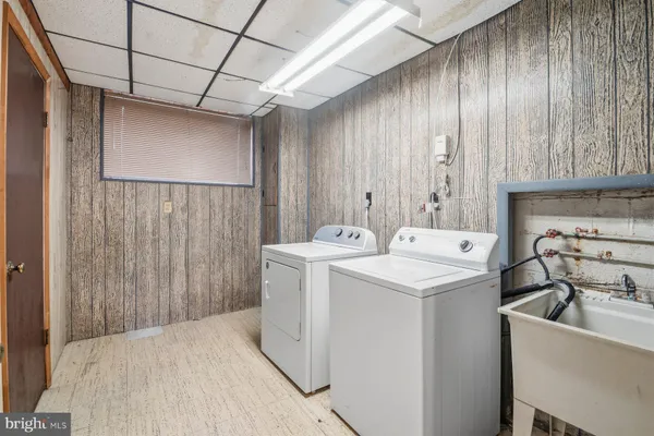 a front view of a house with a garden and trees